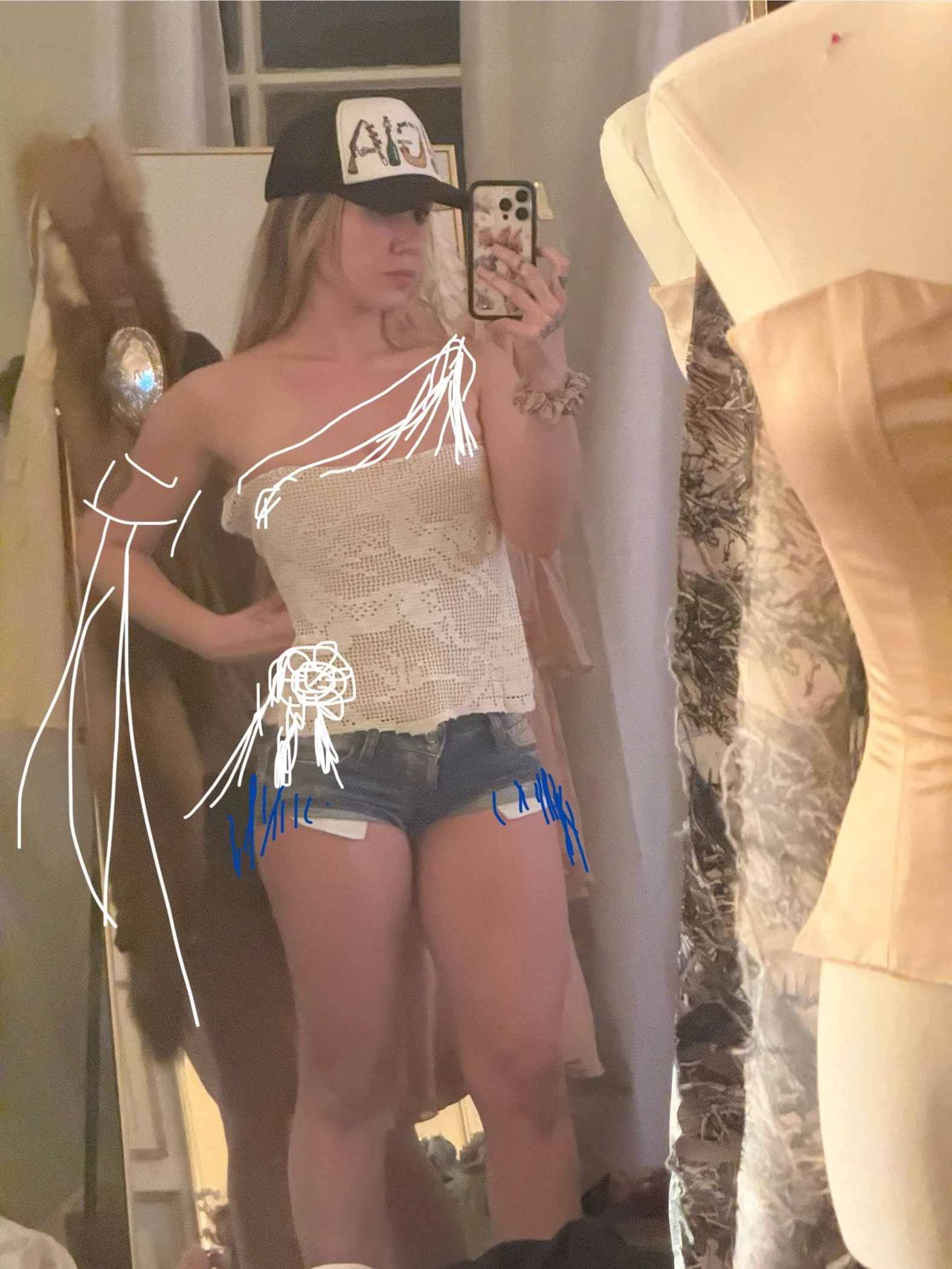 Image may contain Dressing Room Indoors Room Adult Person Electronics Mobile Phone Phone Clothing and Costume