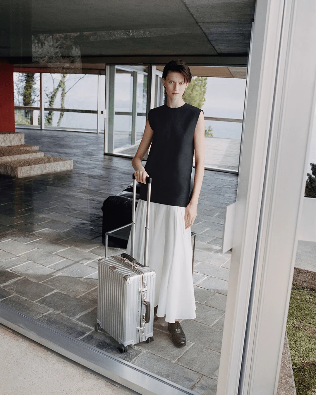 Image may contain Person Teen Baggage Clothing and Skirt