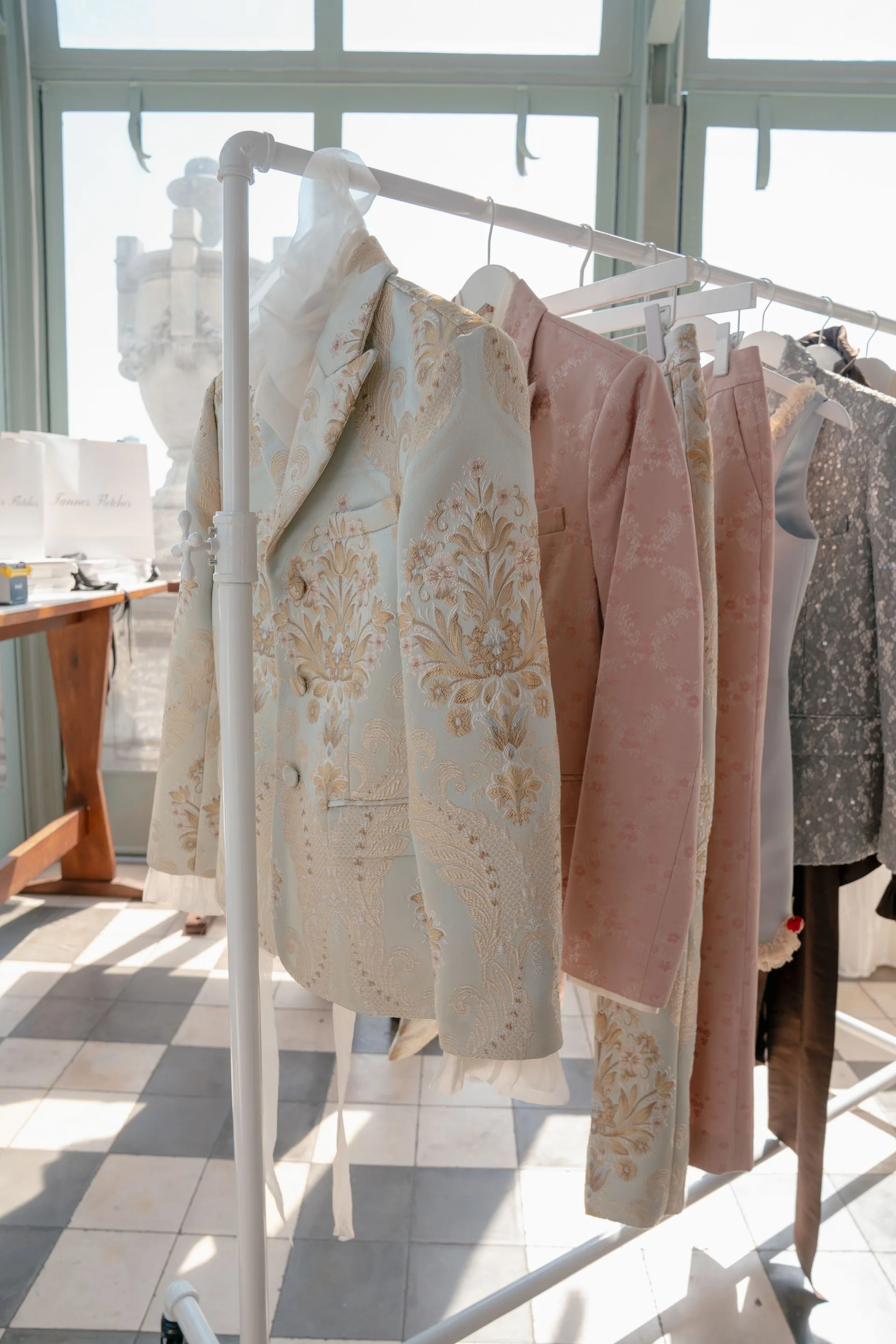 Image may contain Clothing Coat and Furniture